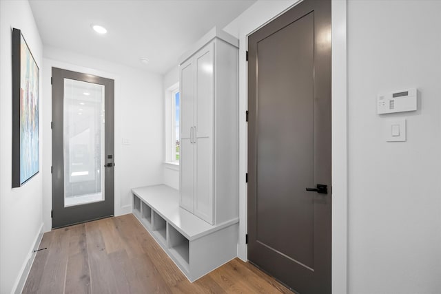 mudroom with wood finished floors and recessed lighting