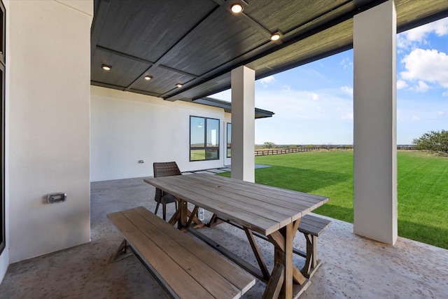 view of patio with fence and outdoor dining area