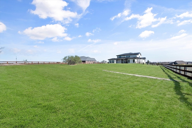 view of yard featuring a rural view and fence