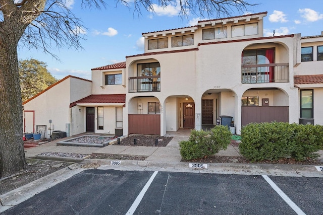 view of property featuring uncovered parking and fence