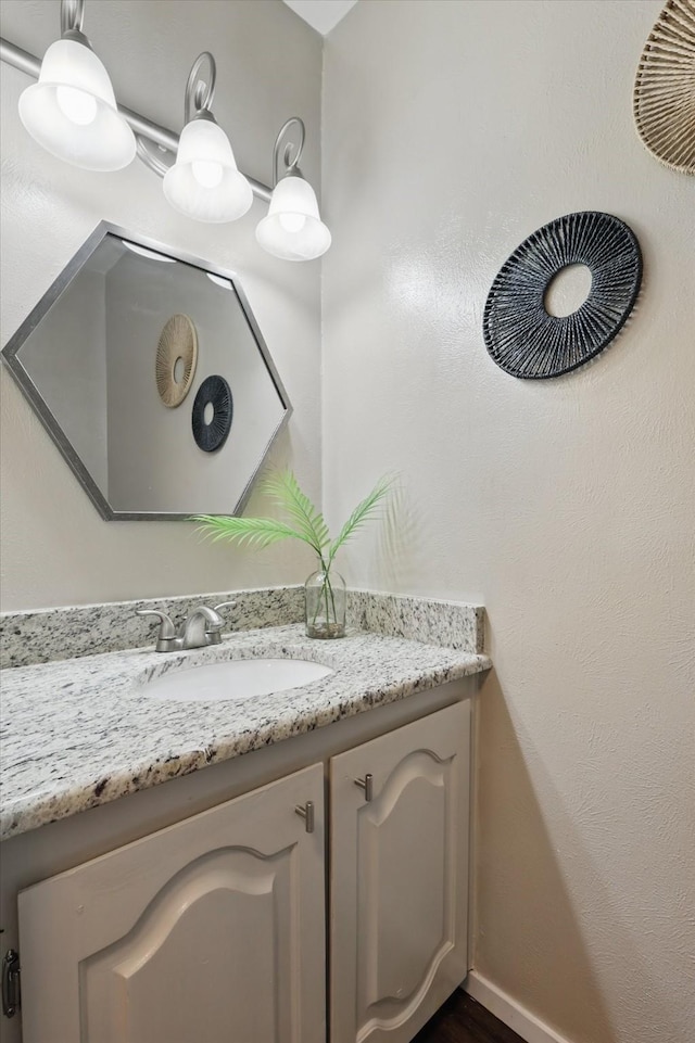 bathroom featuring baseboards and vanity