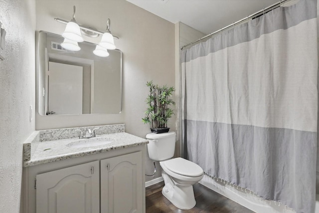 bathroom with visible vents, toilet, wood finished floors, shower / bathtub combination with curtain, and vanity