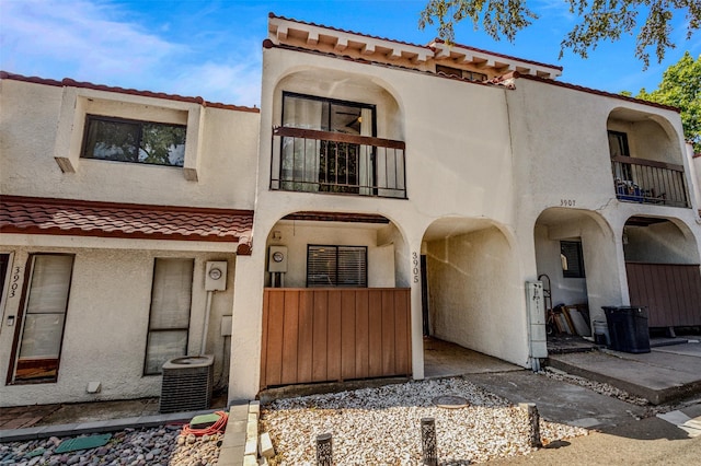 view of front of property with central AC and a balcony