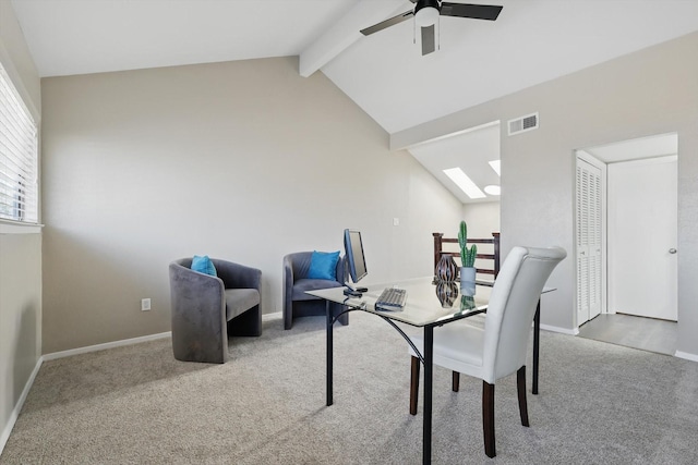 interior space featuring lofted ceiling with skylight, carpet, visible vents, and baseboards