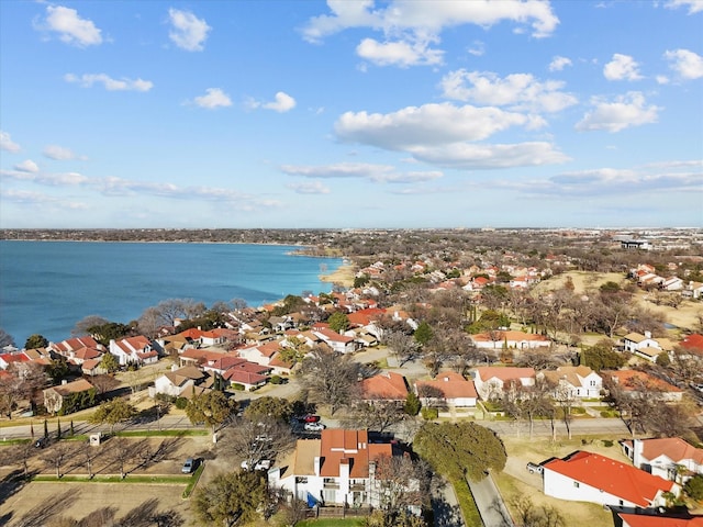 drone / aerial view featuring a residential view and a water view