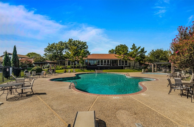 pool with a patio area, fence, and a pergola