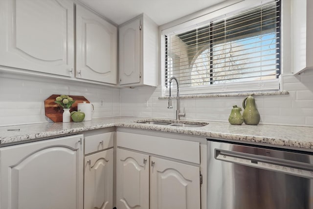 kitchen featuring a sink, white cabinets, dishwasher, and light countertops