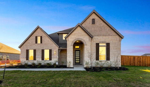 french provincial home featuring a yard