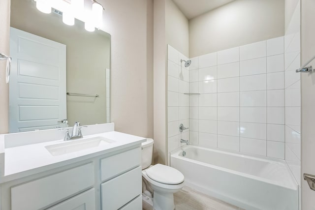 full bathroom featuring vanity, toilet, and tiled shower / bath