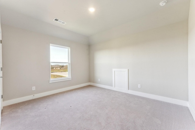 empty room featuring light carpet