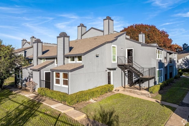 rear view of property featuring a yard