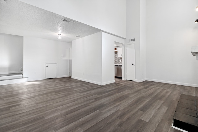 unfurnished living room featuring dark hardwood / wood-style floors and a textured ceiling