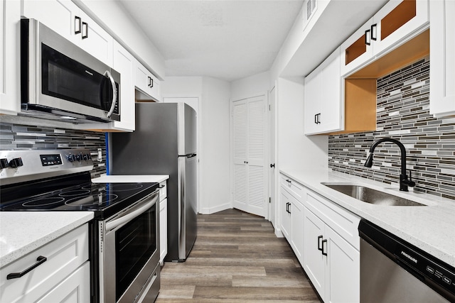 kitchen featuring white cabinets, stainless steel appliances, dark hardwood / wood-style floors, and sink