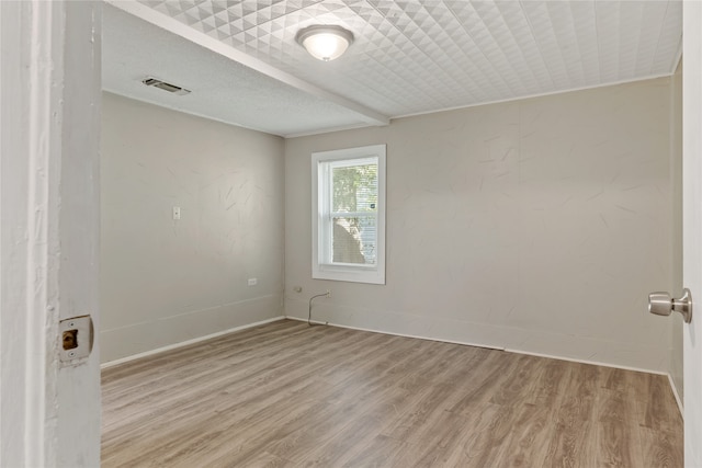 spare room with hardwood / wood-style flooring