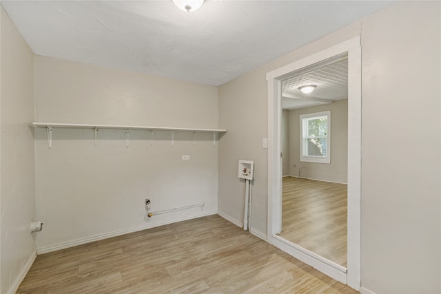 clothes washing area with light wood-type flooring, hookup for a gas dryer, and washer hookup