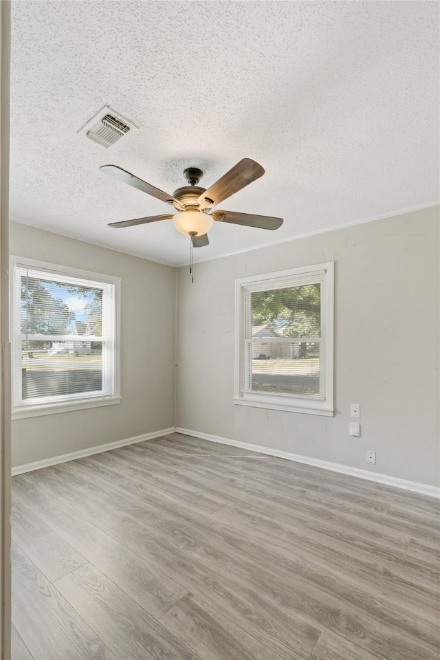 unfurnished room with light hardwood / wood-style floors, a textured ceiling, and ceiling fan