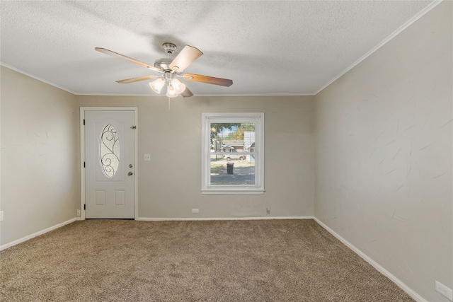 carpeted entrance foyer with crown molding, ceiling fan, and a textured ceiling