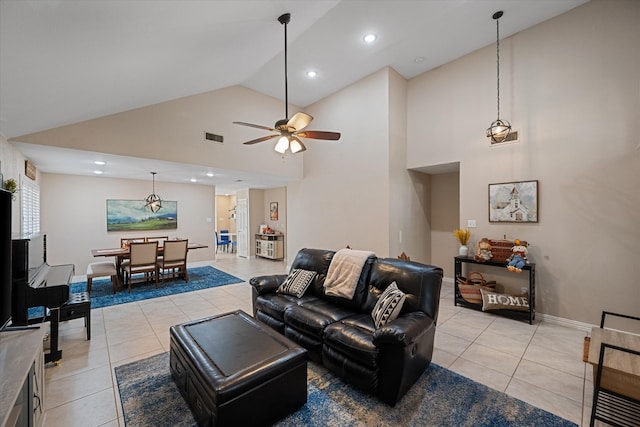 living room with ceiling fan, light tile patterned flooring, and high vaulted ceiling