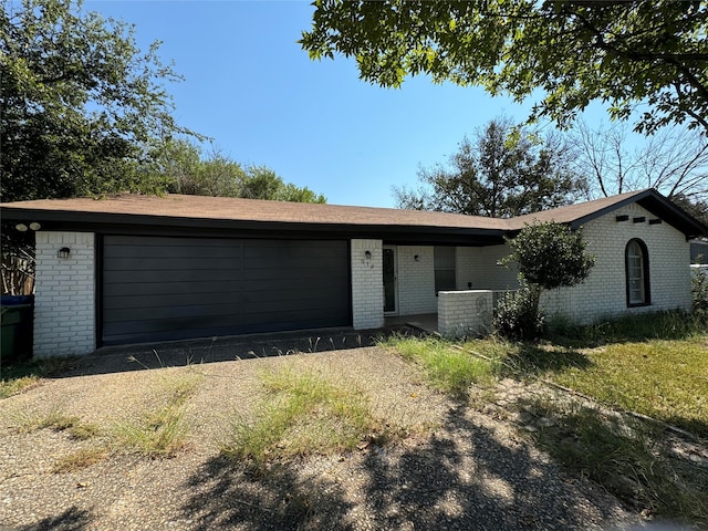 single story home with central air condition unit and a garage