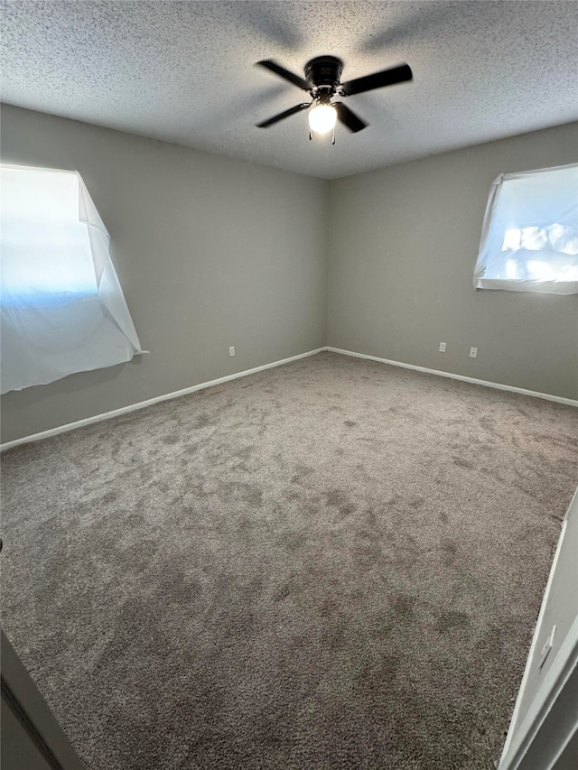 unfurnished room with carpet floors, a textured ceiling, and ceiling fan