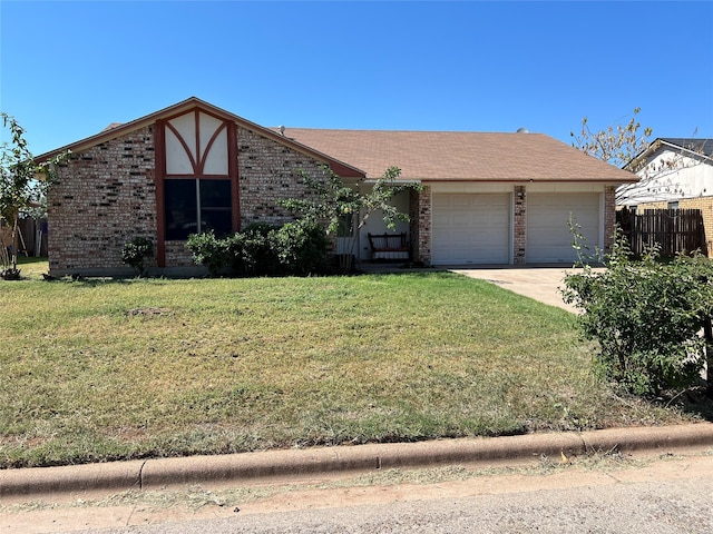 view of front of property with a garage and a front lawn