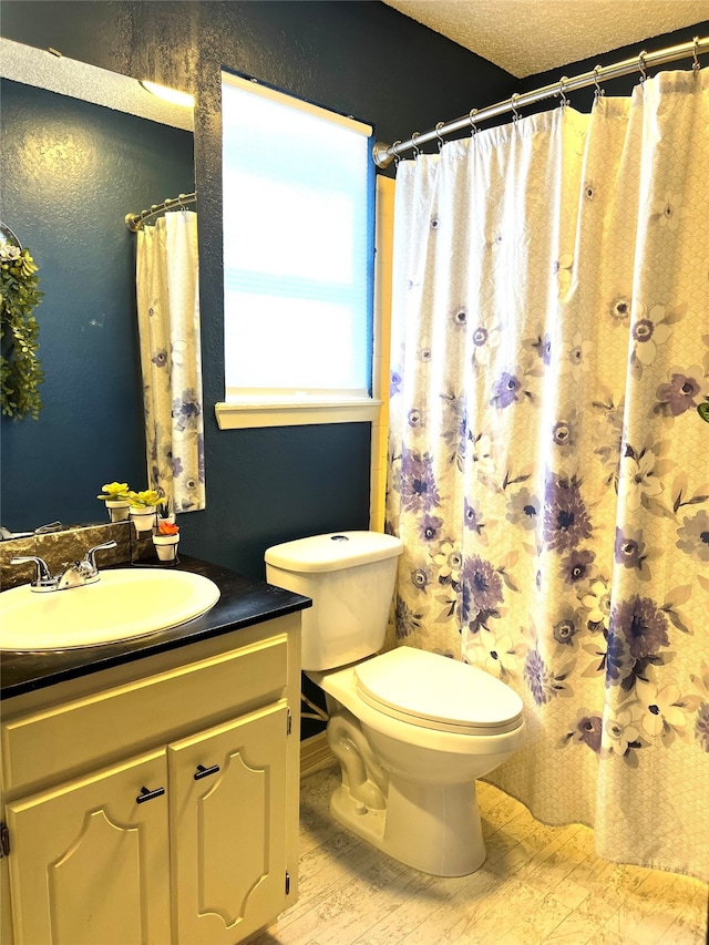 bathroom with vanity, hardwood / wood-style flooring, curtained shower, toilet, and a textured ceiling