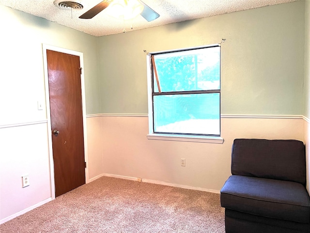 unfurnished room with carpet floors, a textured ceiling, and ceiling fan