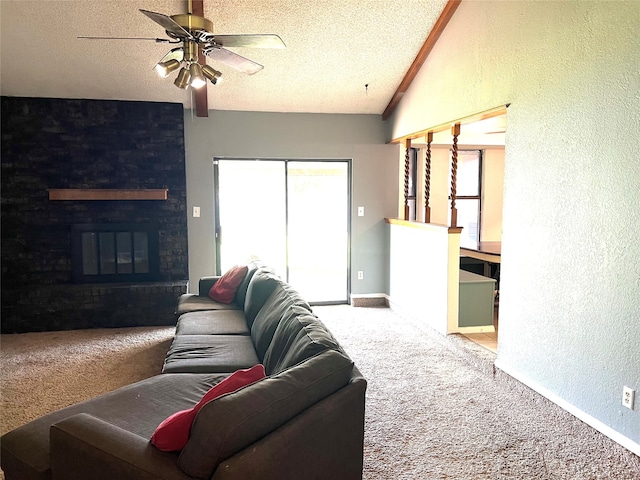 carpeted living room featuring ceiling fan, a textured ceiling, a fireplace, and vaulted ceiling