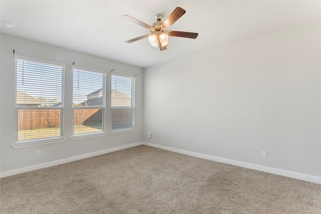 unfurnished room featuring ceiling fan and carpet