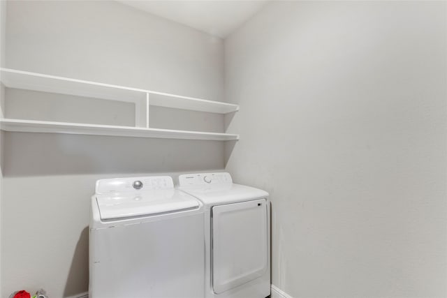 clothes washing area with washer and dryer