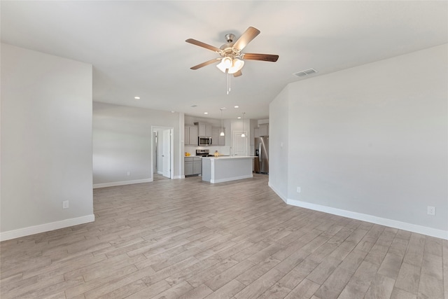 unfurnished living room featuring light hardwood / wood-style flooring and ceiling fan