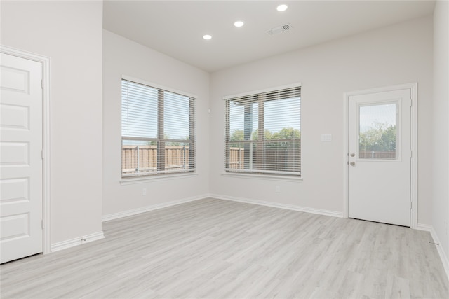 empty room with light hardwood / wood-style floors