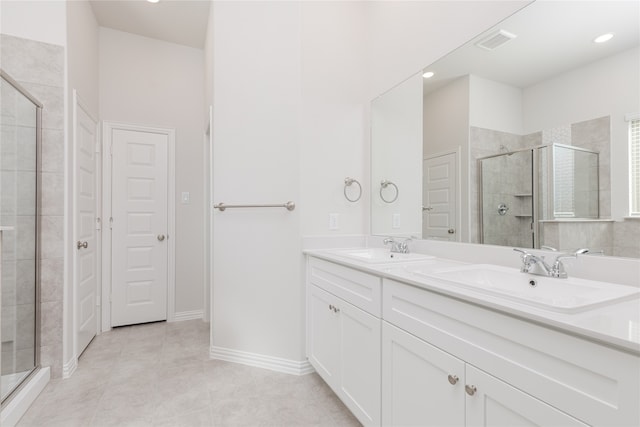 bathroom with vanity, tile patterned flooring, and walk in shower