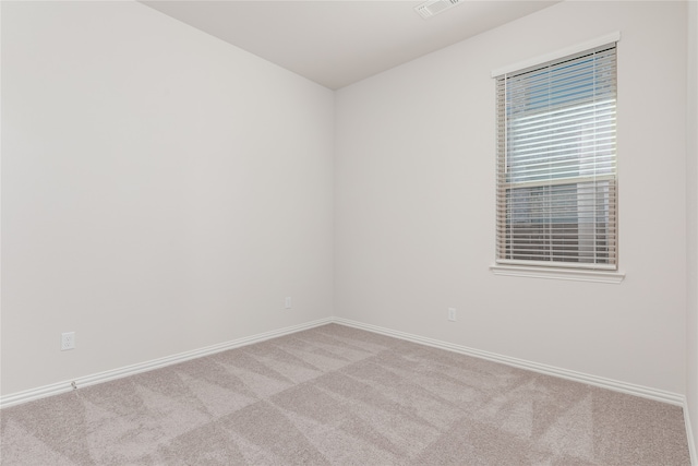 unfurnished room with light colored carpet