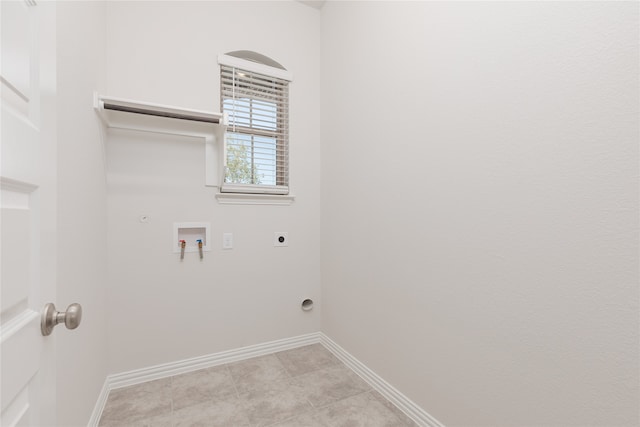 washroom with hookup for a gas dryer, electric dryer hookup, washer hookup, and light tile patterned floors