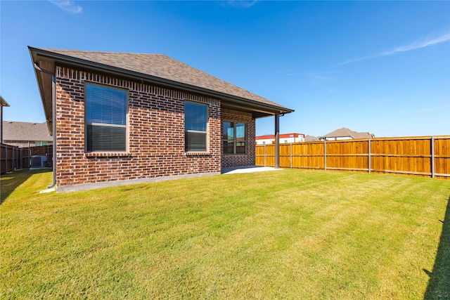 rear view of house featuring a patio area, a lawn, and central AC unit