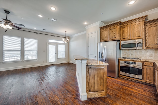 kitchen with tasteful backsplash, crown molding, a kitchen island, dark hardwood / wood-style floors, and appliances with stainless steel finishes