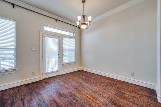 doorway featuring plenty of natural light, ornamental molding, dark hardwood / wood-style floors, and a chandelier