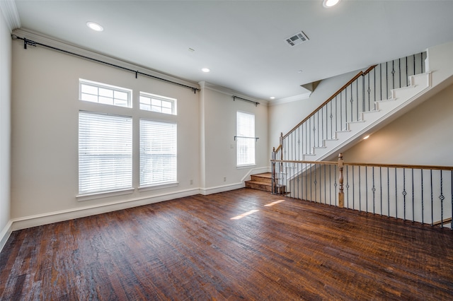 empty room with dark wood-type flooring and ornamental molding