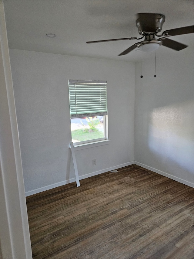 empty room featuring ceiling fan and dark hardwood / wood-style flooring