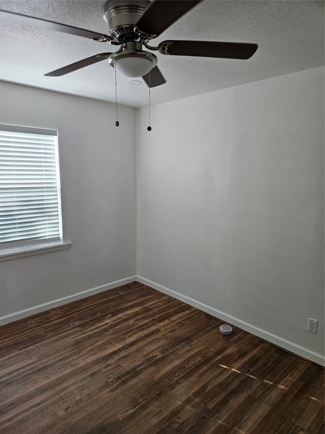 unfurnished room featuring ceiling fan and dark hardwood / wood-style flooring