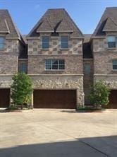 view of front of house featuring central AC unit and a garage