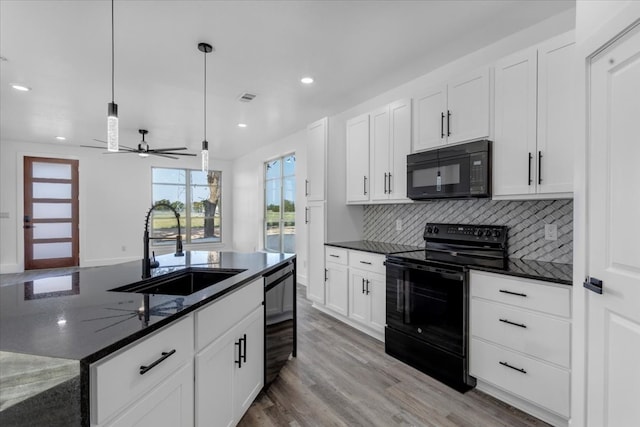 kitchen with white cabinetry, black appliances, sink, and pendant lighting