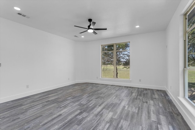 empty room featuring ceiling fan and dark hardwood / wood-style flooring