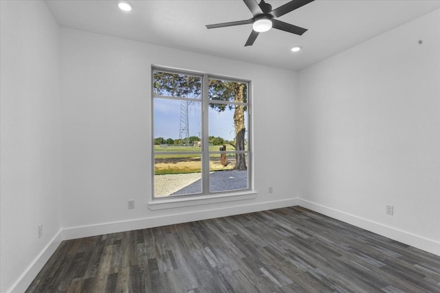 empty room with dark wood-type flooring and ceiling fan