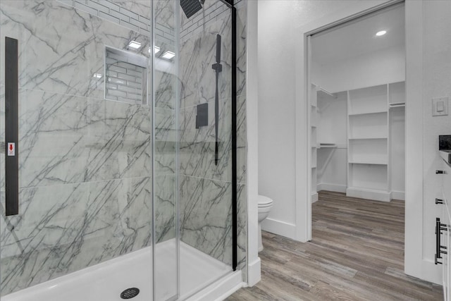 bathroom with a shower with door, wood-type flooring, and toilet