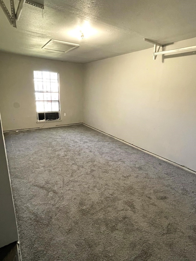 carpeted spare room featuring a textured ceiling