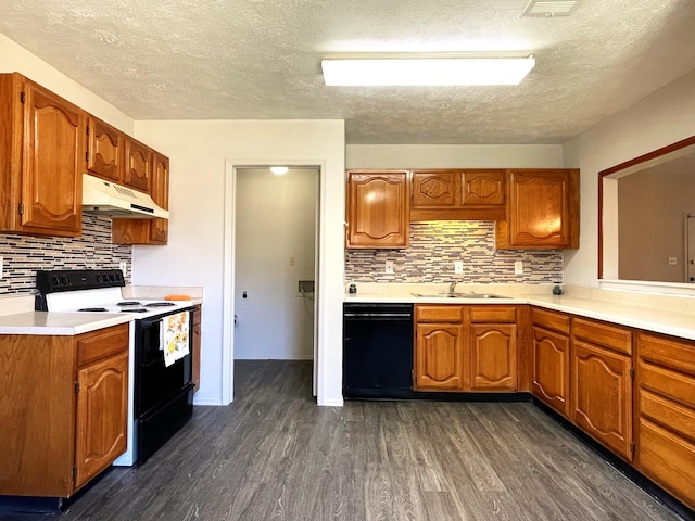 kitchen featuring tasteful backsplash, black appliances, sink, a textured ceiling, and dark wood-type flooring