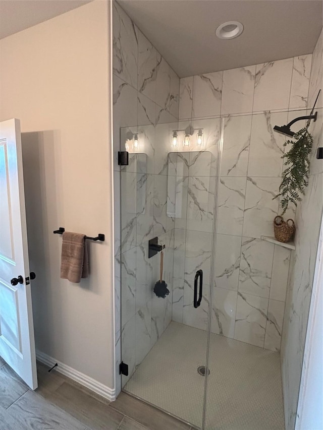 bathroom with a shower with shower door