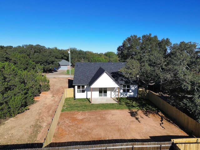 rear view of house featuring a lawn and a patio area